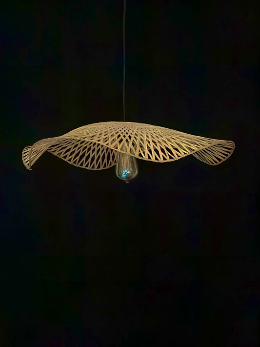 Woven pendant light fixture on a dark background