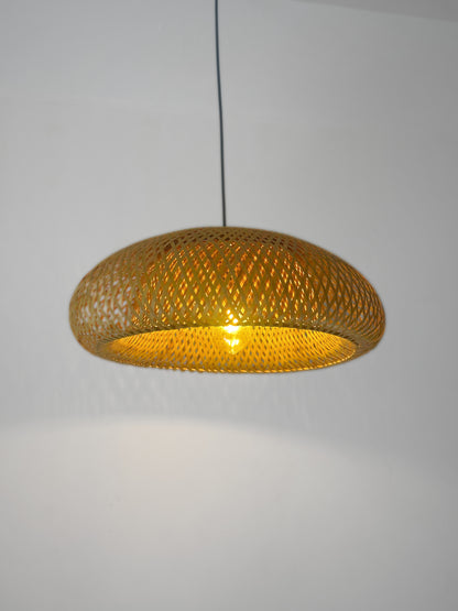 Woven pendant light with a gold finish on a plain background