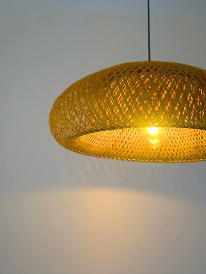 Yellow woven pendant light against a plain background